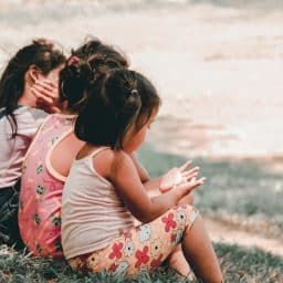 Children sitting on grass