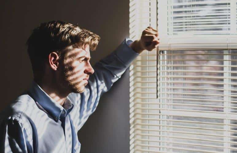 Depression and Hearing Loss Man looks outside of window