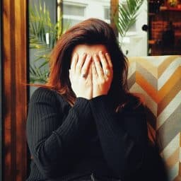 Woman covering her face