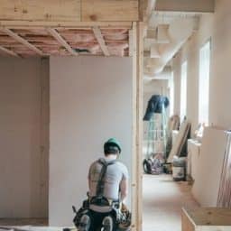 Construction worker man working on an incomplete building.