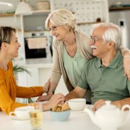 Adult daughter enjoying a pleasant chat with her parents.