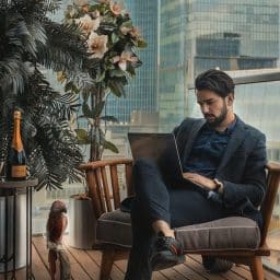A business man using his laptop outside.