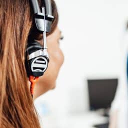 Woman with headphones getting a hearing test.