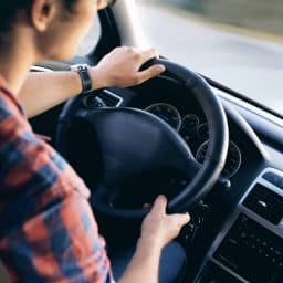 Close-up of a person driving a car.