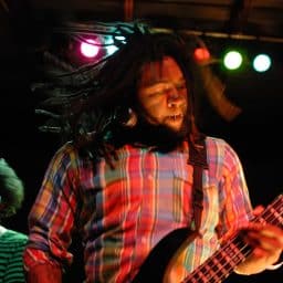 Band members perform on stage
