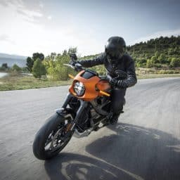 Man riding his motorcycle on an open road.