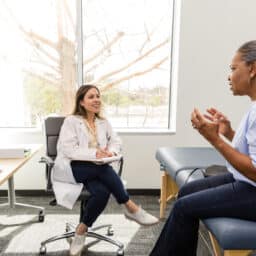 Patient explaining her tinnitus to her audiologist