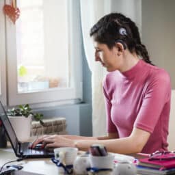 Woman wears cochlear implant