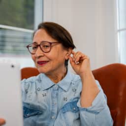 Woman checking out her new hearing aid.