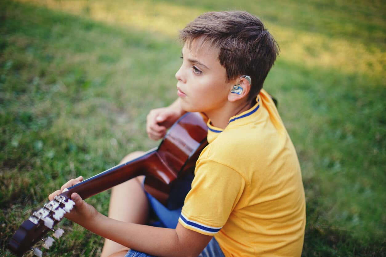 Young boy wears hearing aid