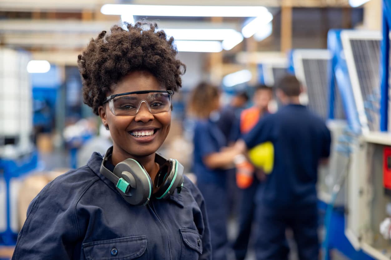 woman wearing hearing protection around neck in factory
