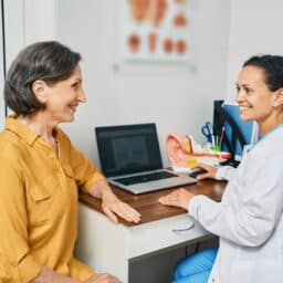 Consultation with experienced female audiologist to mature woman patient at medical clinic. Treatment of hearing loss in senior people
