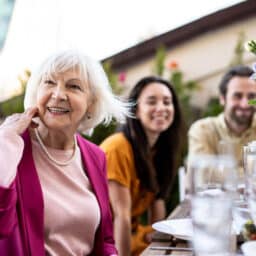 group of people dining on a rooftop. Family and friends make a reunion at home, eating and having fun